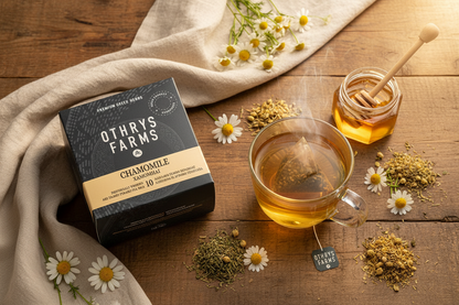 Othrys Farms Chamomile tea flat lay with pyramid bag steeping, chamomile flowers and honey on wood