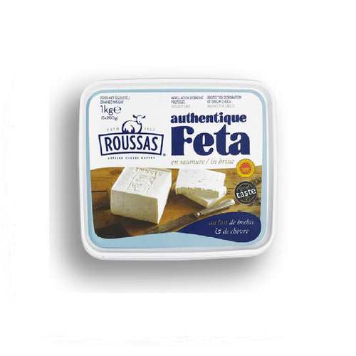 A close-up photo of Authentic Traditional Greek Roussas Feta Cheese, showing its crumbly texture and rich cream color.